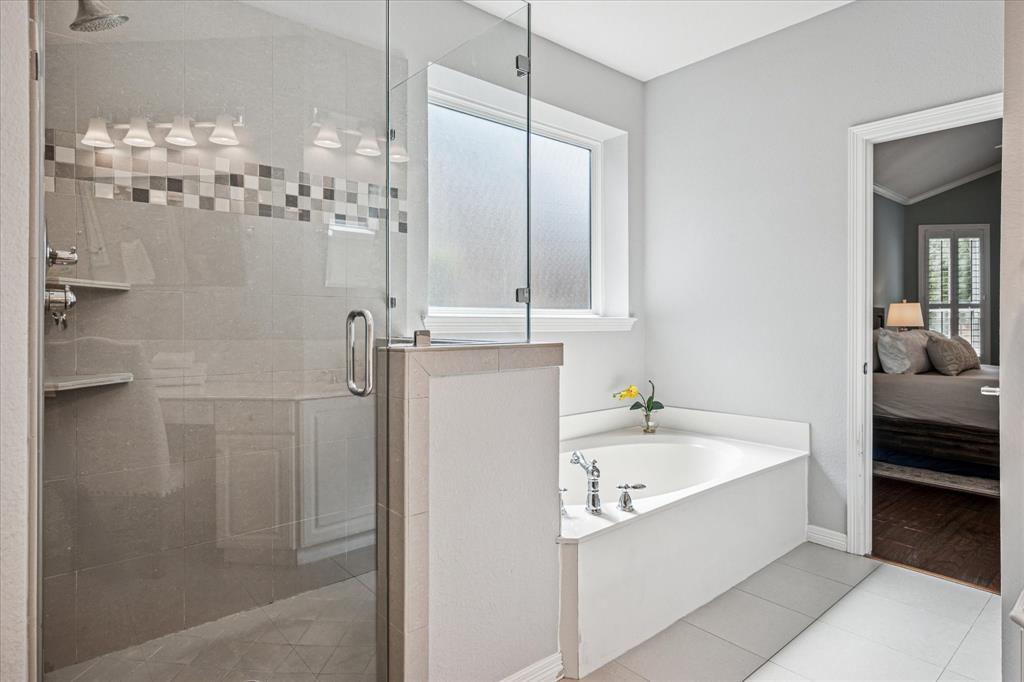 7509 Cedar Elm Drive Irving, TX 75063 - Photo 17 of 40 a bathroom with a bathtub and a sink