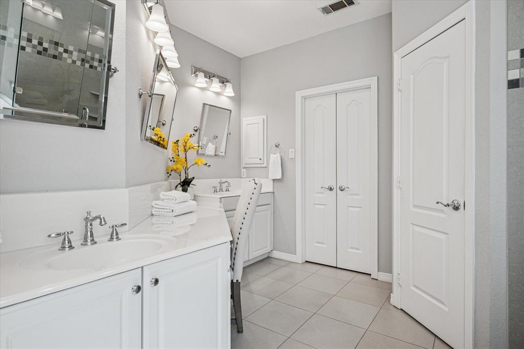 7509 Cedar Elm Drive Irving, TX 75063 - Photo 18 of 40 a bathroom with a sink vanity and mirror