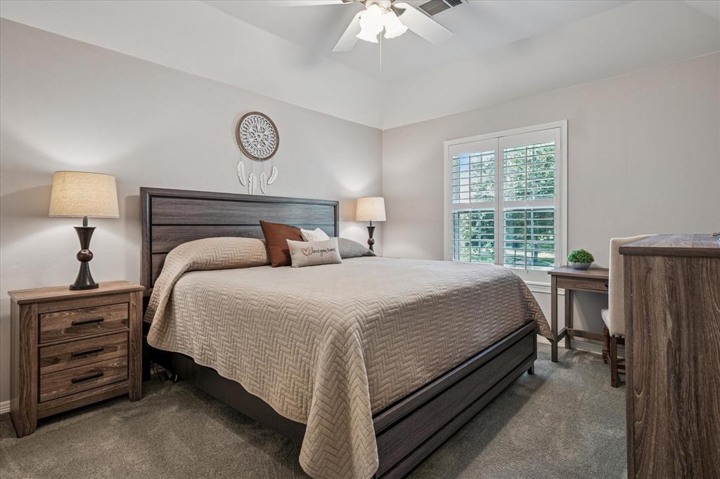 7509 Cedar Elm Drive Irving, TX 75063 - Photo 22 of 40 a bedroom with a bed and a night stand