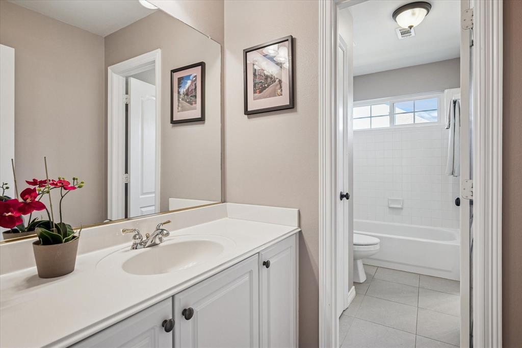 7509 Cedar Elm Drive Irving, TX 75063 - Photo 25 of 40 a bathroom with a sink a toilet and shower