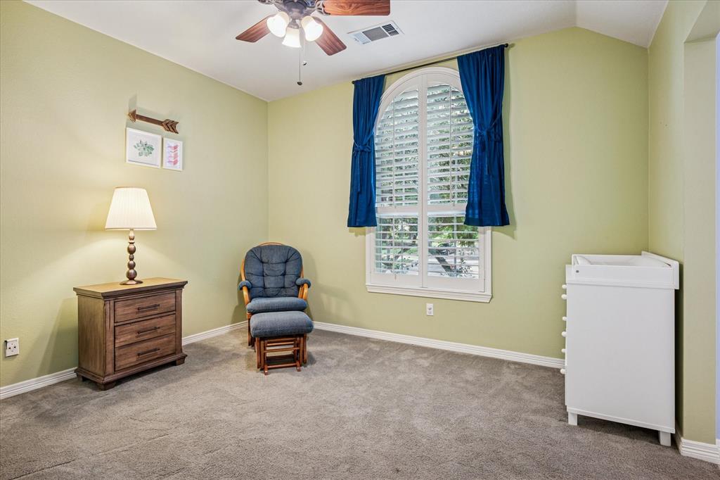 7509 Cedar Elm Drive Irving, TX 75063 - Photo 26 of 40 a bedroom with a bed and a chandelier