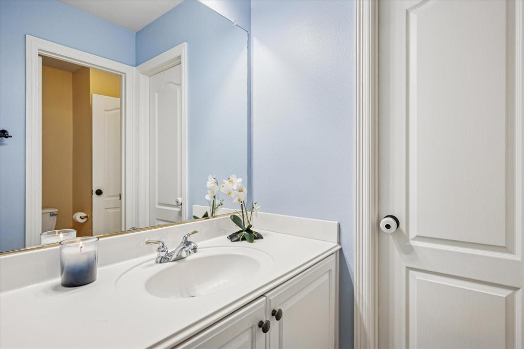 7509 Cedar Elm Drive Irving, TX 75063 - Photo 28 of 40 a bathroom with a sink and a mirror