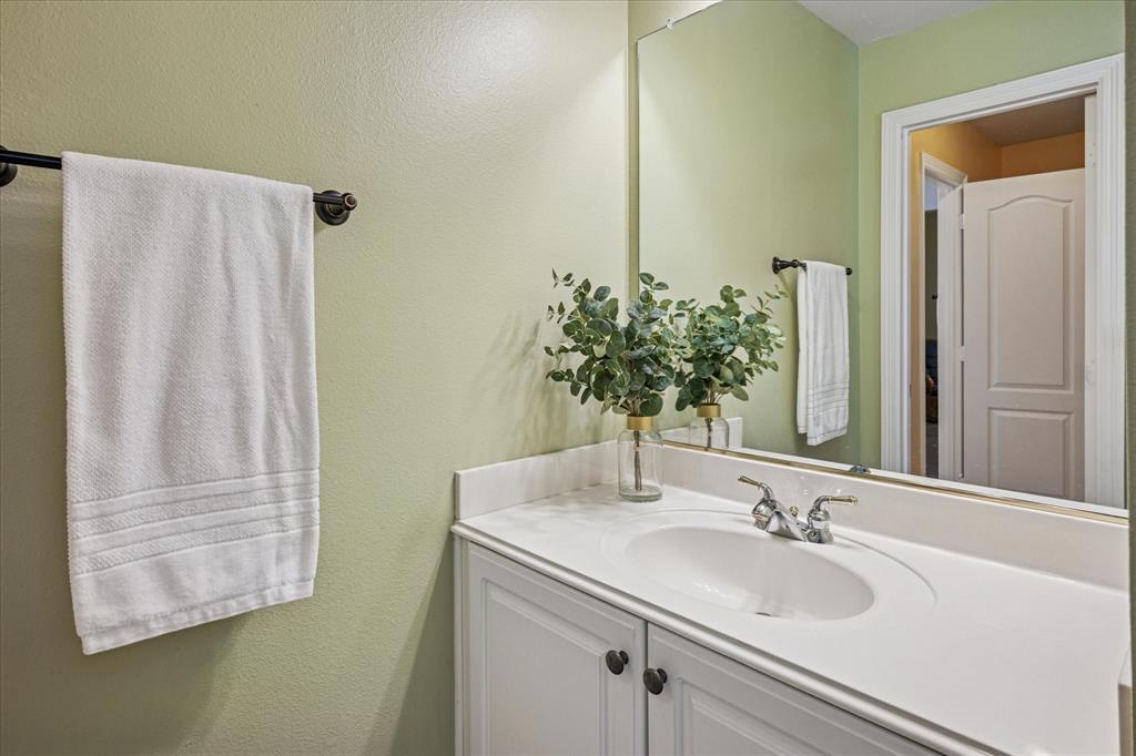 7509 Cedar Elm Drive Irving, TX 75063 - Photo 30 of 40 a bathroom with a sink and a mirror