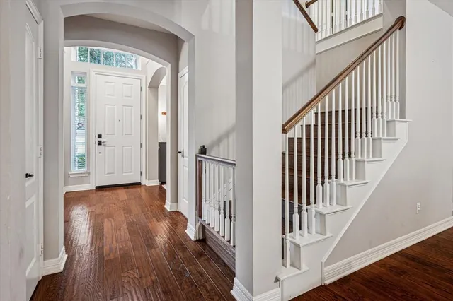 a view of a hallway with wooden floor and entryway