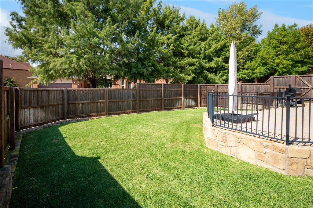 7509 Cedar Elm Drive Irving, TX 75063 - Photo 35 of 40 a view of a backyard with a small garden and trees