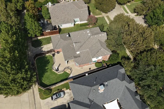 an aerial view of a residential houses with outdoor space and street view
