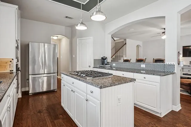 a kitchen with a stove a refrigerator and a sink