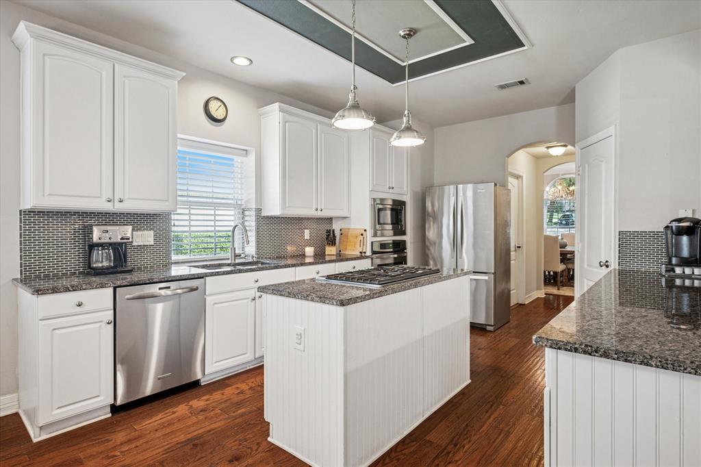 7509 Cedar Elm Drive Irving, TX 75063 - Photo 10 of 40 a kitchen with stainless steel appliances granite countertop a stove and a sink
