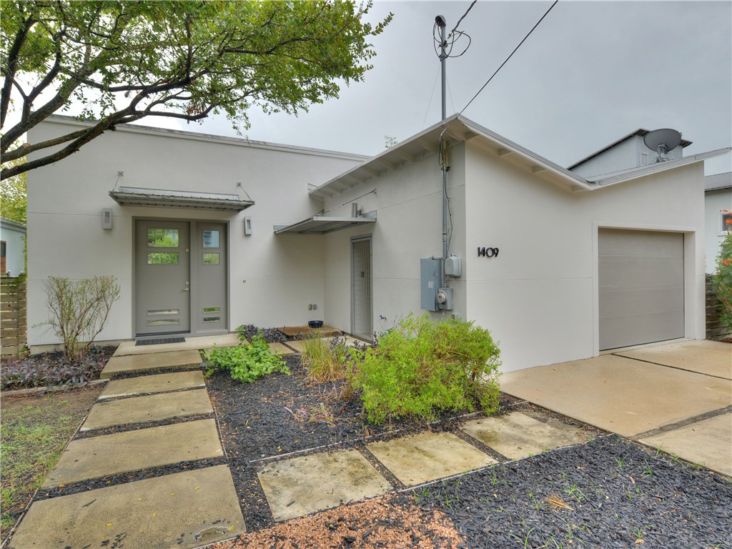 1409 Luna Street Austin, TX 78721 - Photo 1 of 1 a front view of a house with garden