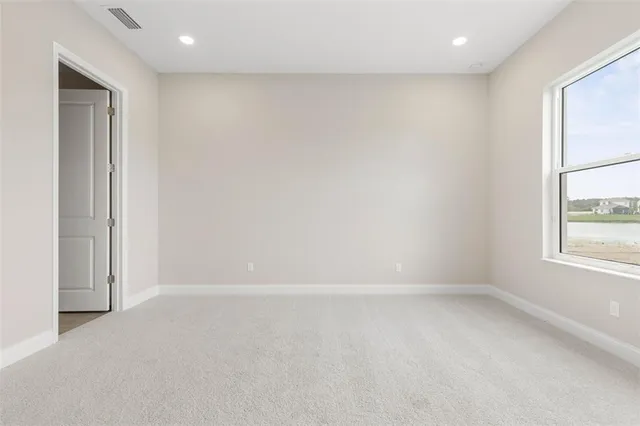 a view of kitchen with stainless steel appliances granite countertop refrigerator and stove