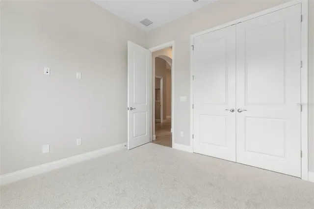 an aerial view of a city with lots of residential buildings ocean and mountain view in back