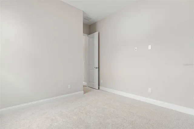an aerial view of a house with a garden and lake view