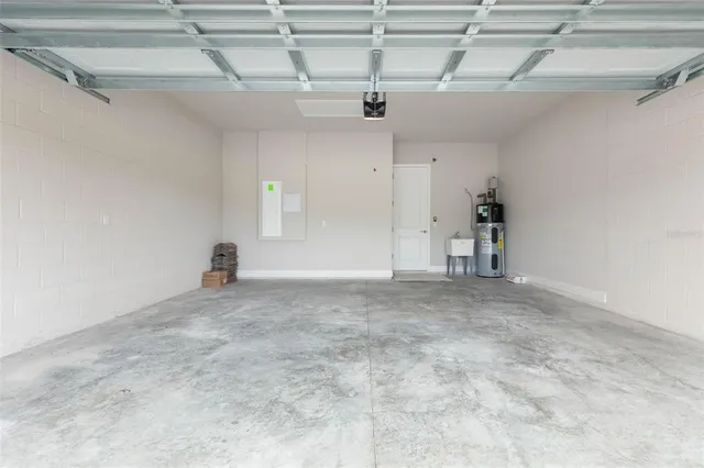 an aerial view of a house with a garden and lake view