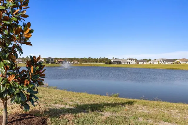 a view of a house with backyard sitting area and swimming pool