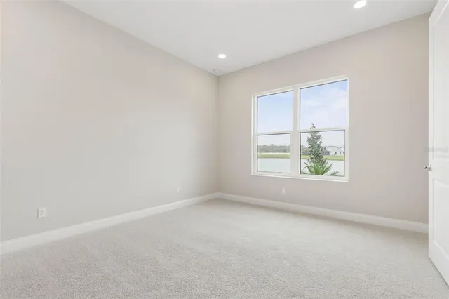a view of an empty room and wooden floor