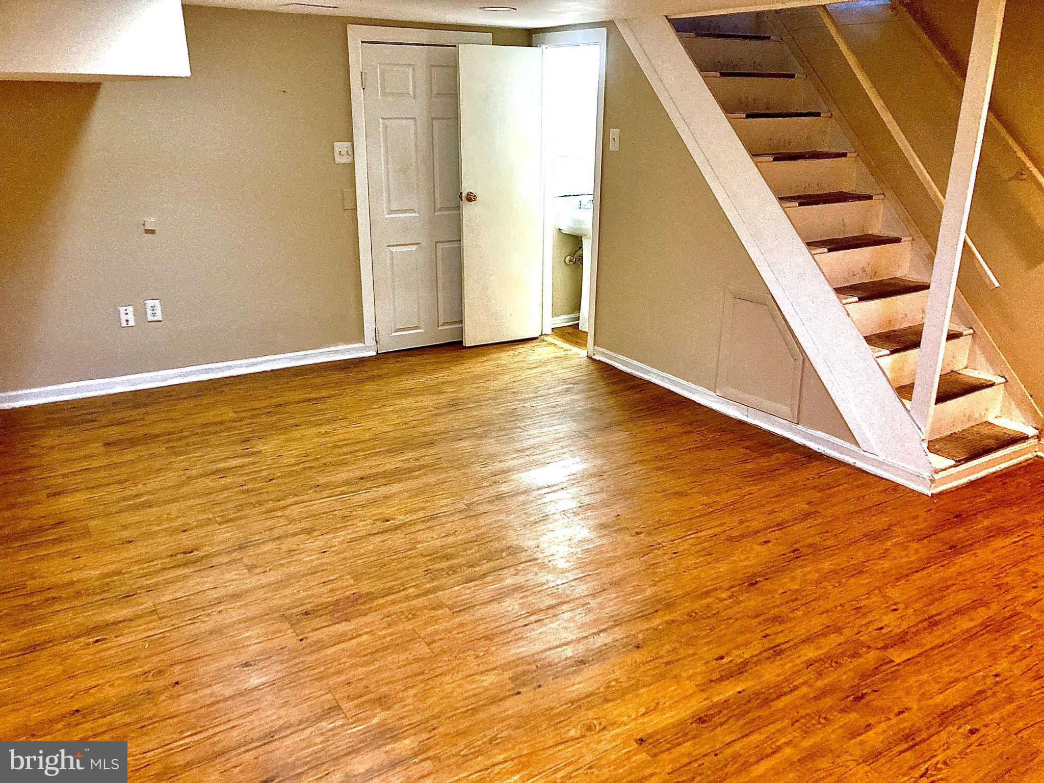 247 West Meadow Road Baltimore, MD 21225 - Photo 13 of 28 Family Room with Laminate Floor & Powder Rm