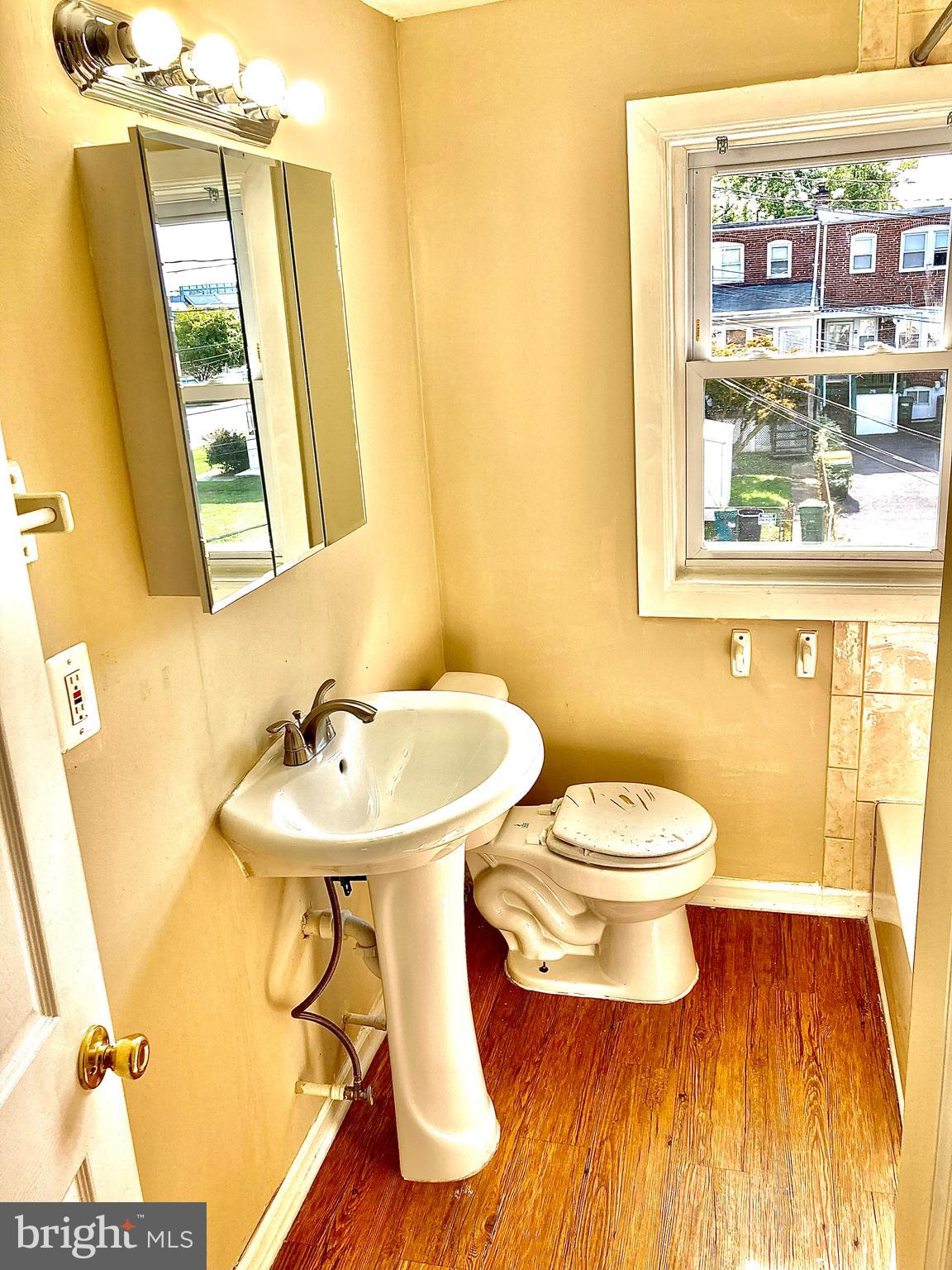 247 West Meadow Road Baltimore, MD 21225 - Photo 22 of 28 Bath w/ pedestal sink & laminate floor