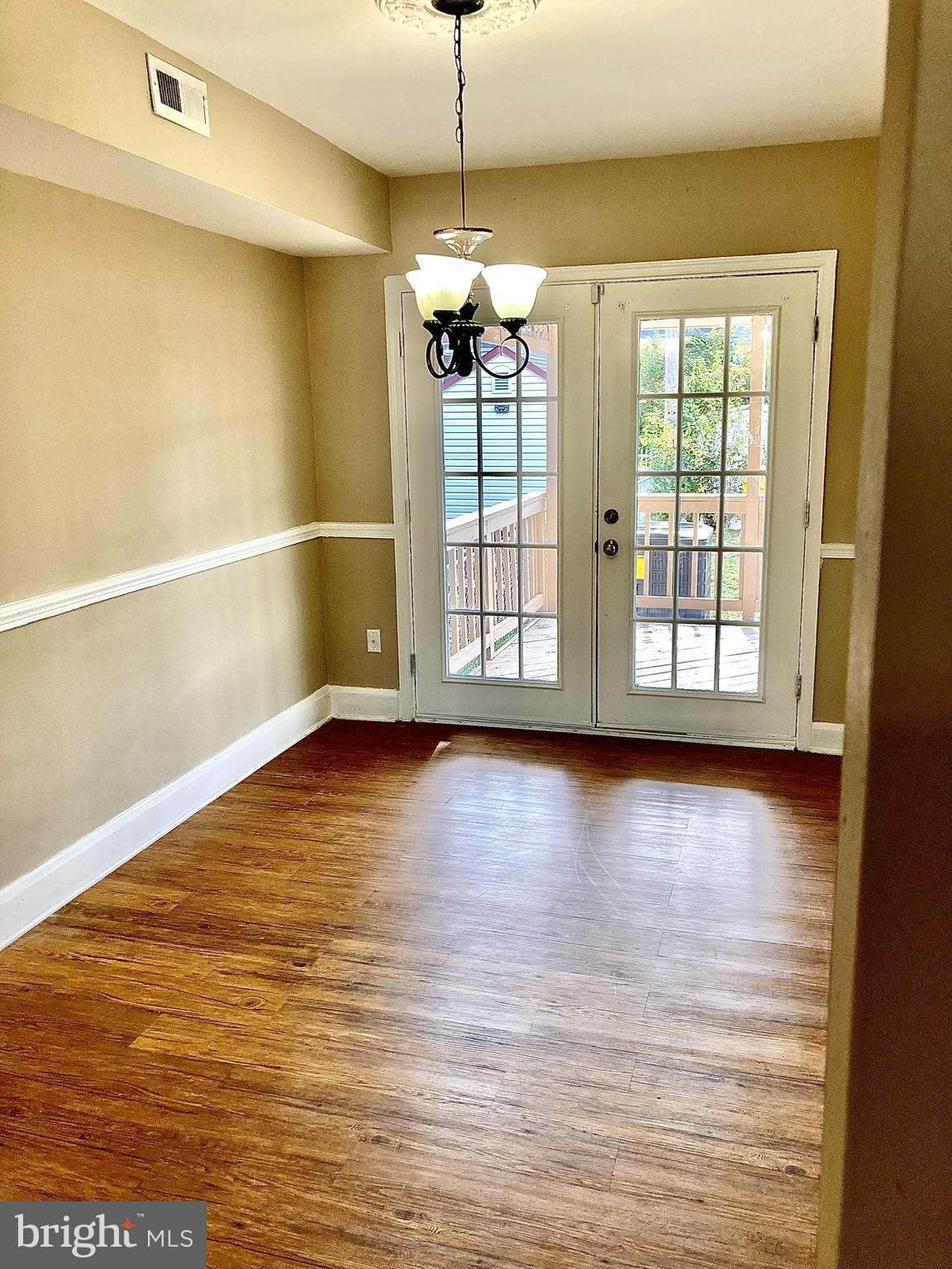 247 West Meadow Road Baltimore, MD 21225 - Photo 7 of 28 Dining Rm with Chair Rail molding & French Doors