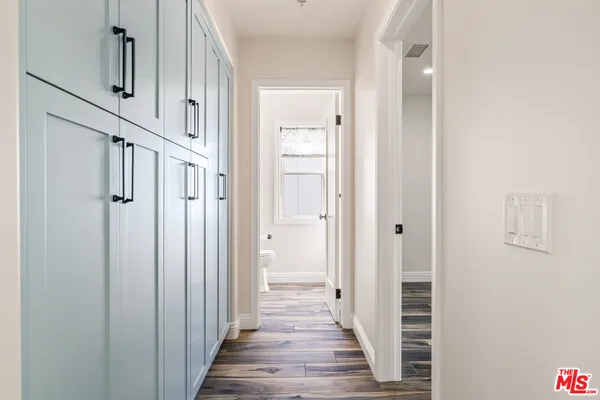 a view of an empty room with a window and closet