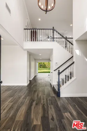a view of staircase with white walls and a window