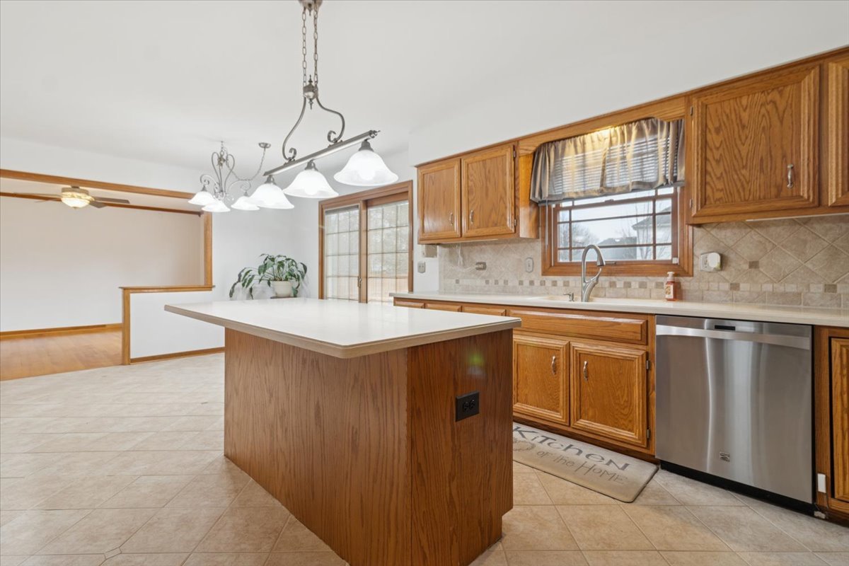 818 Wescott Road Bolingbrook, IL 60440 - Photo 11 of 33 a kitchen with a sink cabinets and window