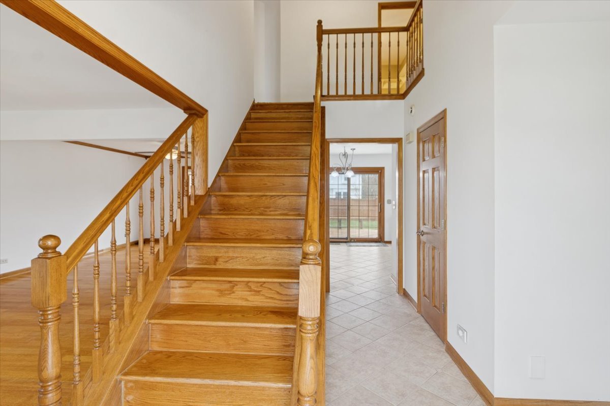 818 Wescott Road Bolingbrook, IL 60440 - Photo 16 of 33 a view of staircase with railing and white walls