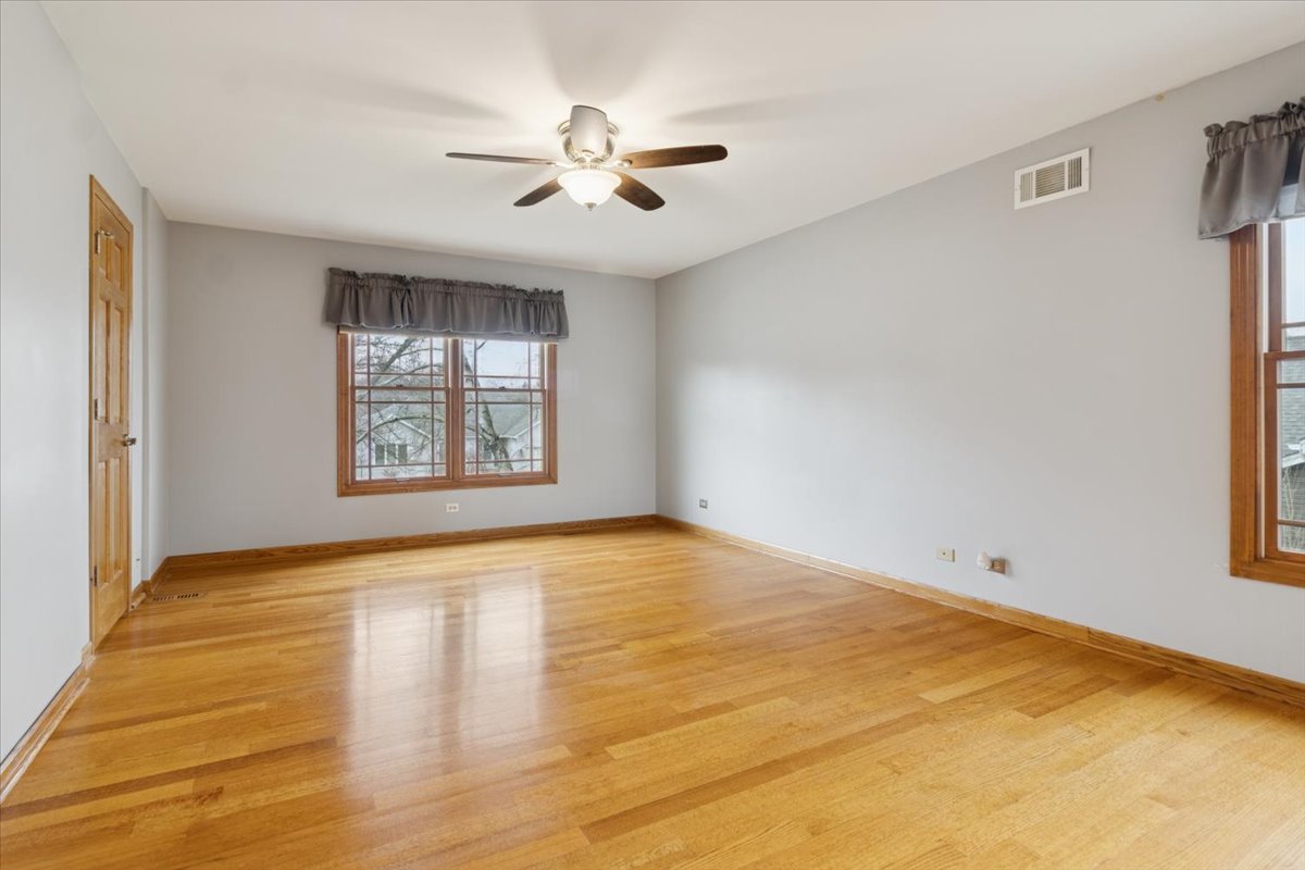 818 Wescott Road Bolingbrook, IL 60440 - Photo 18 of 33 a view of an empty room with a window and wooden floor
