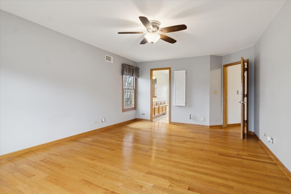818 Wescott Road Bolingbrook, IL 60440 - Photo 19 of 33 a view of an empty room with window and wooden floor