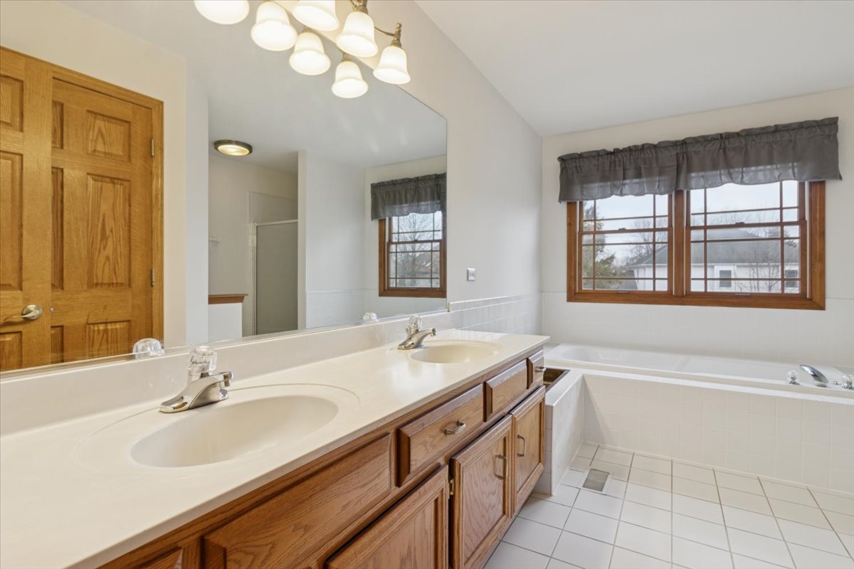 818 Wescott Road Bolingbrook, IL 60440 - Photo 20 of 33 a bathroom with a sink a vanity and a mirror