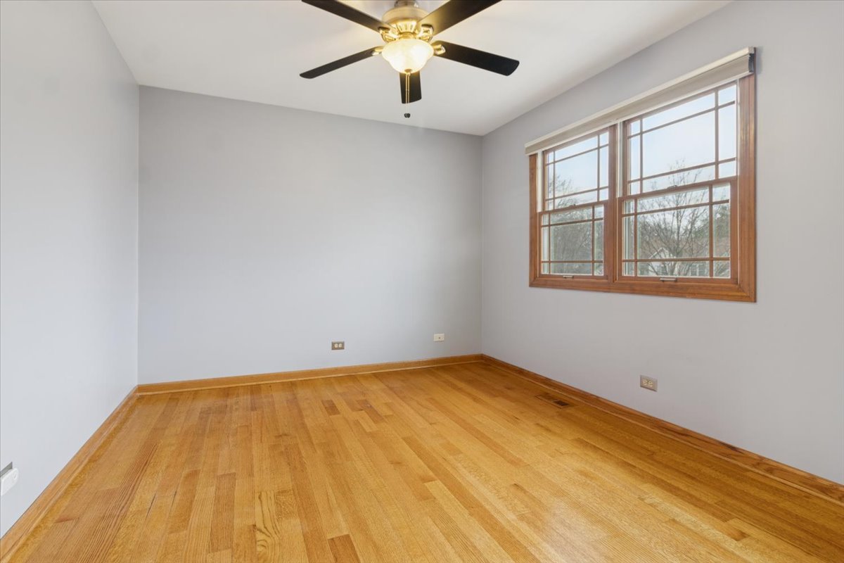 818 Wescott Road Bolingbrook, IL 60440 - Photo 21 of 33 an empty room with a window and ceiling fan
