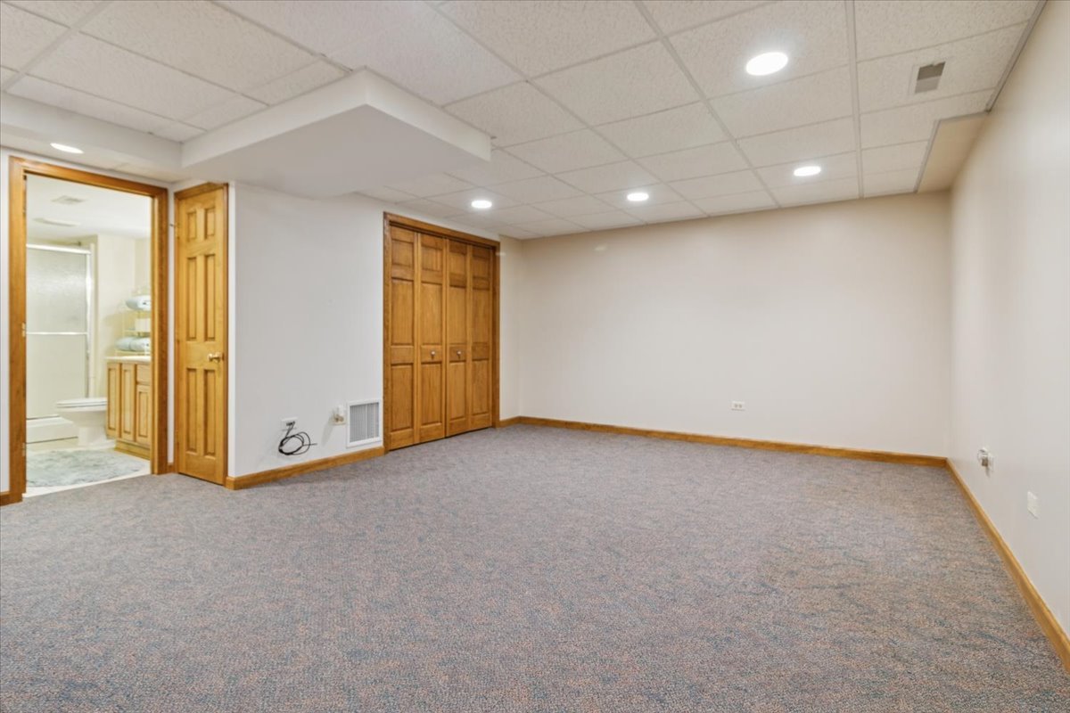 818 Wescott Road Bolingbrook, IL 60440 - Photo 27 of 33 wooden floor in an empty room with a window