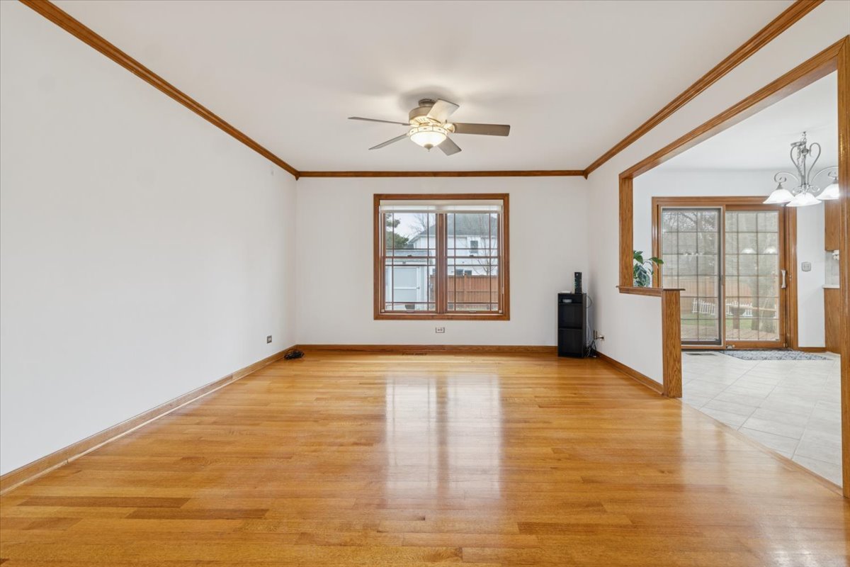 818 Wescott Road Bolingbrook, IL 60440 - Photo 7 of 33 an empty room with wooden floor and windows