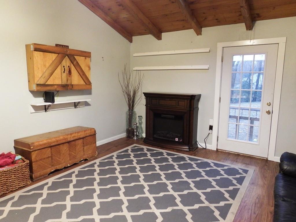 859 Turnpike Road Ashby, MA 01431 - Photo 11 of 22 a living room with furniture and a fireplace