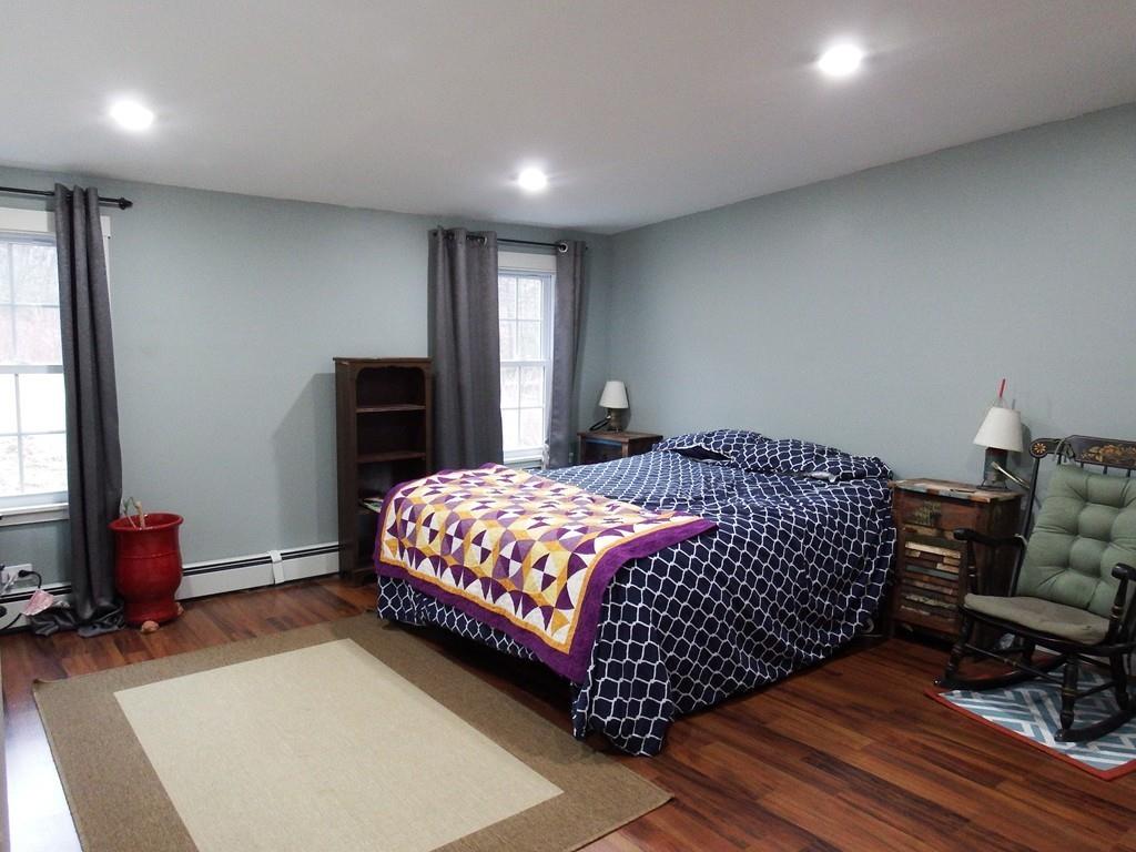 859 Turnpike Road Ashby, MA 01431 - Photo 12 of 22 a bedroom with a bed and wooden floor