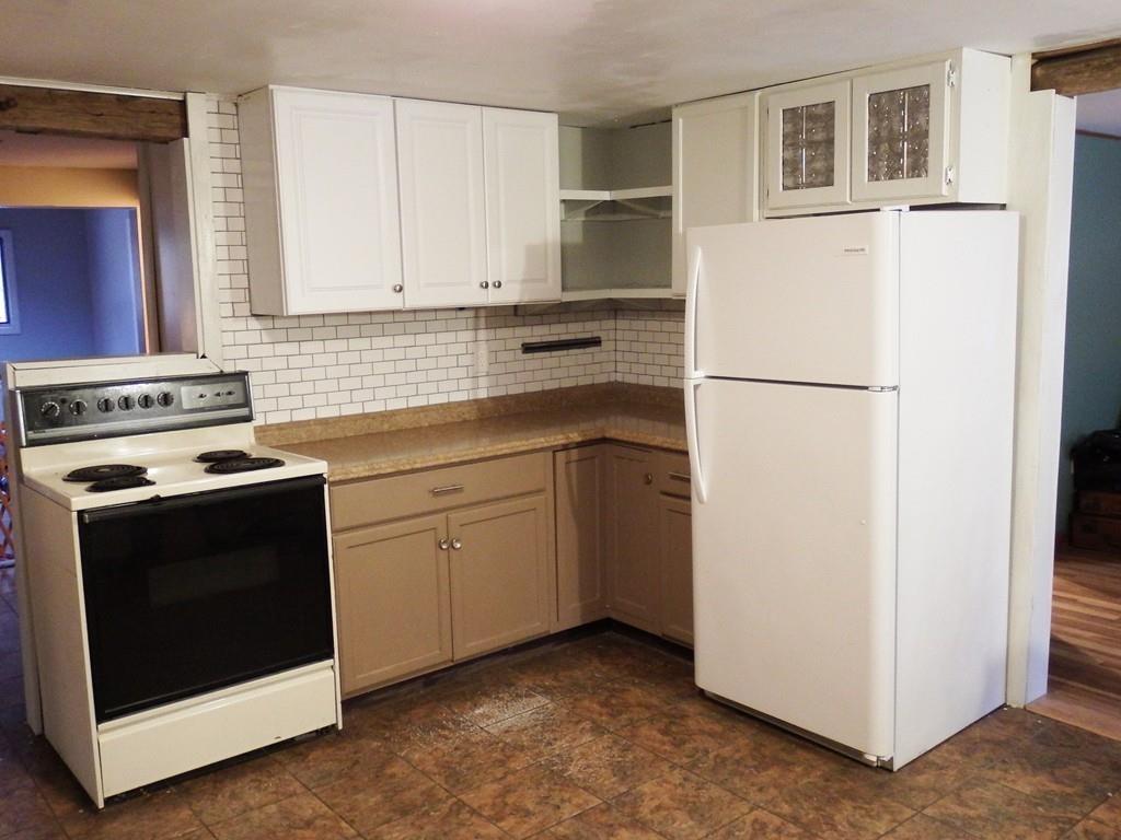 859 Turnpike Road Ashby, MA 01431 - Photo 3 of 22 a kitchen with cabinets and white appliances