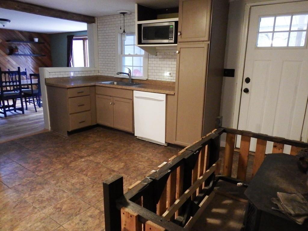 859 Turnpike Road Ashby, MA 01431 - Photo 4 of 22 a kitchen with granite countertop a stove a microwave and a refrigerator