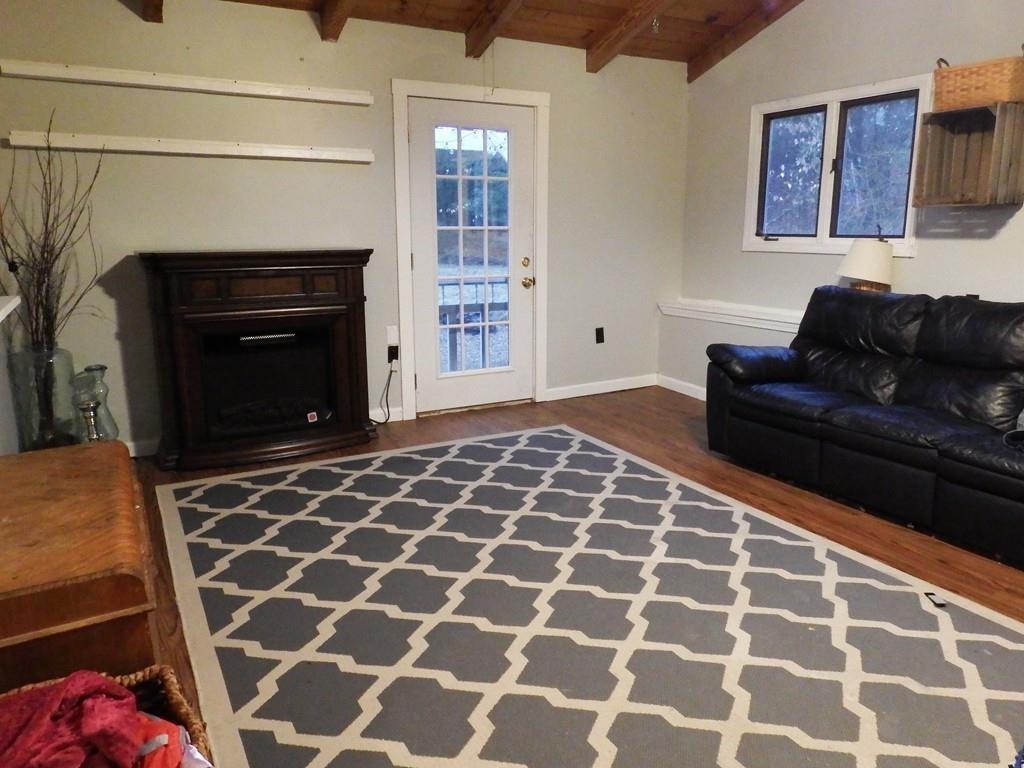859 Turnpike Road Ashby, MA 01431 - Photo 10 of 22 a living room with a couch and a fireplace