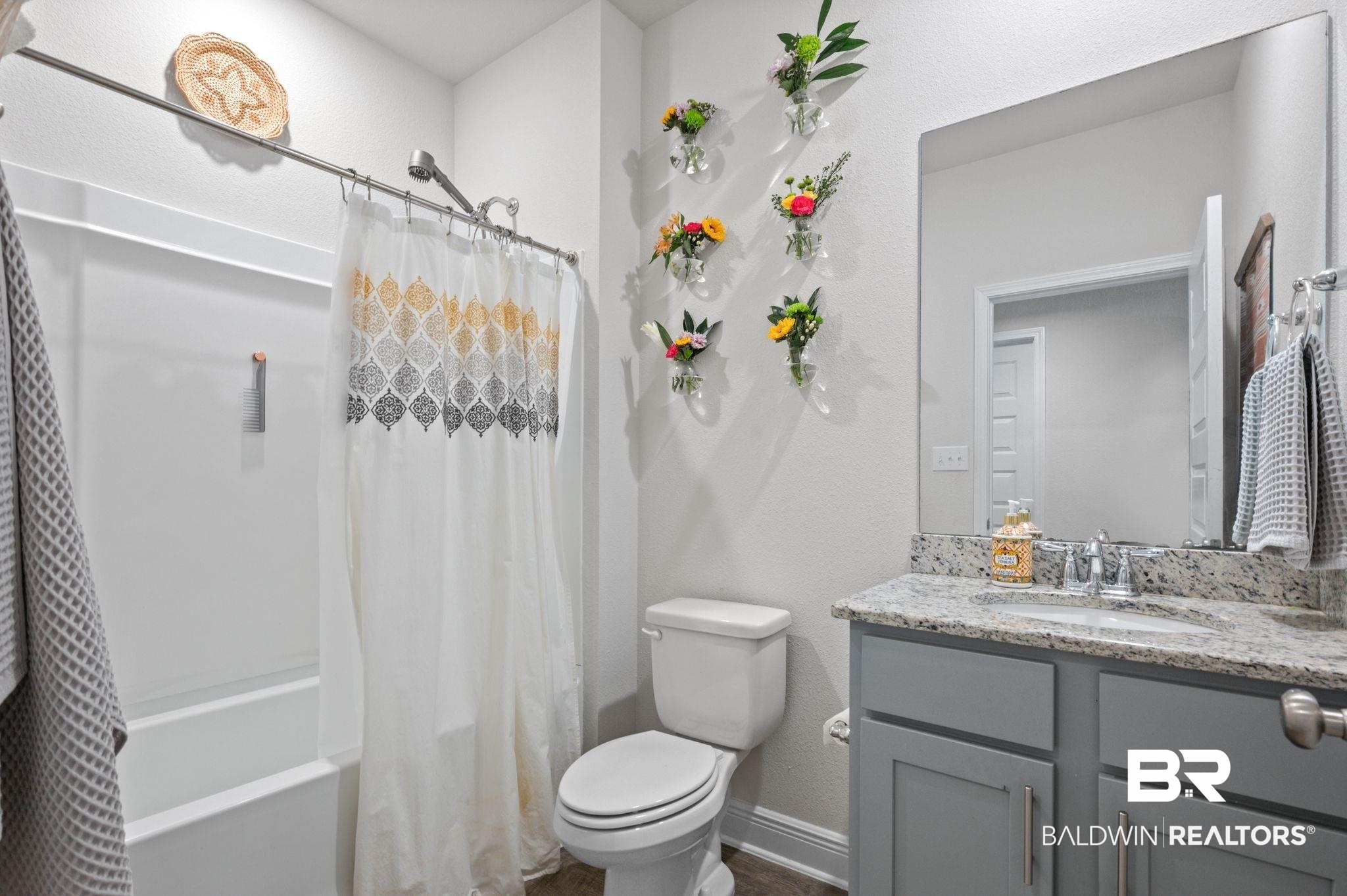24891 Spectacular Bid Loop Daphne, AL 36526 - Photo 35 of 51 Full bathroom with vanity, shower / tub combo with curtain, and toilet