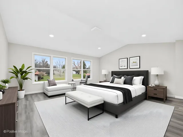 a spacious bedroom with a bed and a couch