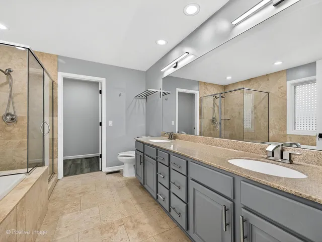 a spacious bathroom with a double vanity sink mirror double and shower