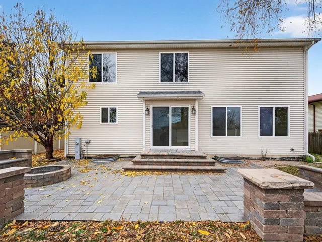 a view of a backyard with table and chairs with wooden fence