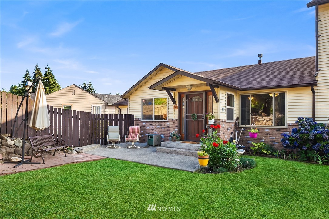 573 Bronson Place Northeast Renton, WA 98056 - Photo 2 of 32 a front view of a house with porch and garden