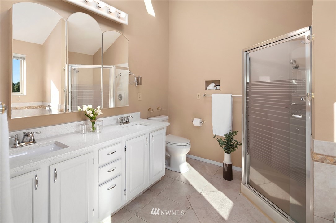573 Bronson Place Northeast Renton, WA 98056 - Photo 13 of 32 a spacious bathroom with a double vanity sink a mirror and a shower