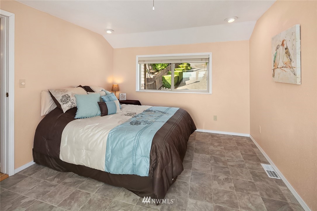 573 Bronson Place Northeast Renton, WA 98056 - Photo 16 of 32 a bedroom with a bed and painting on the wall