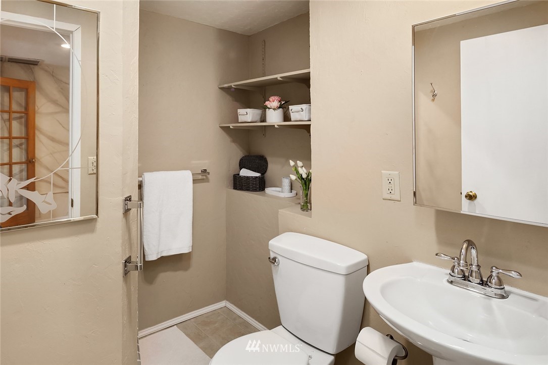573 Bronson Place Northeast Renton, WA 98056 - Photo 24 of 32 a bathroom with a toilet sink and mirror