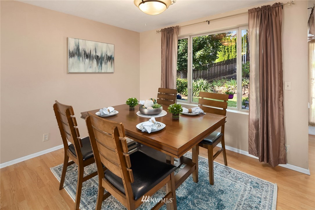 573 Bronson Place Northeast Renton, WA 98056 - Photo 4 of 32 a view of a dining room with furniture window and wooden floor