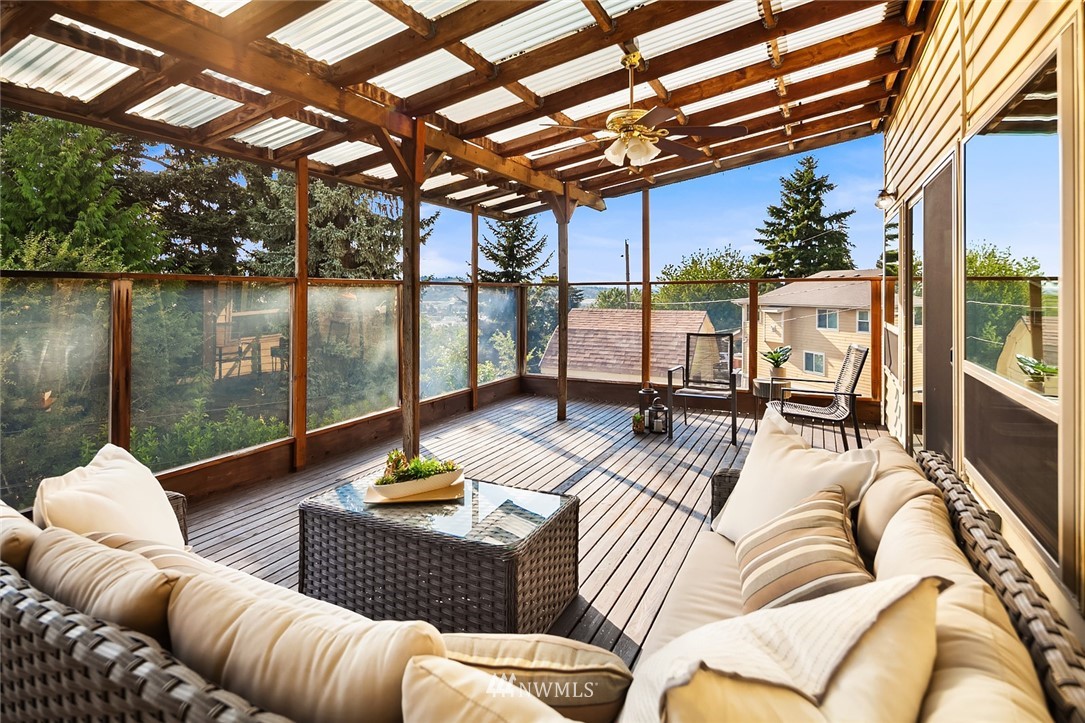 573 Bronson Place Northeast Renton, WA 98056 - Photo 9 of 32 a view of a patio with couches chairs and wooden floor