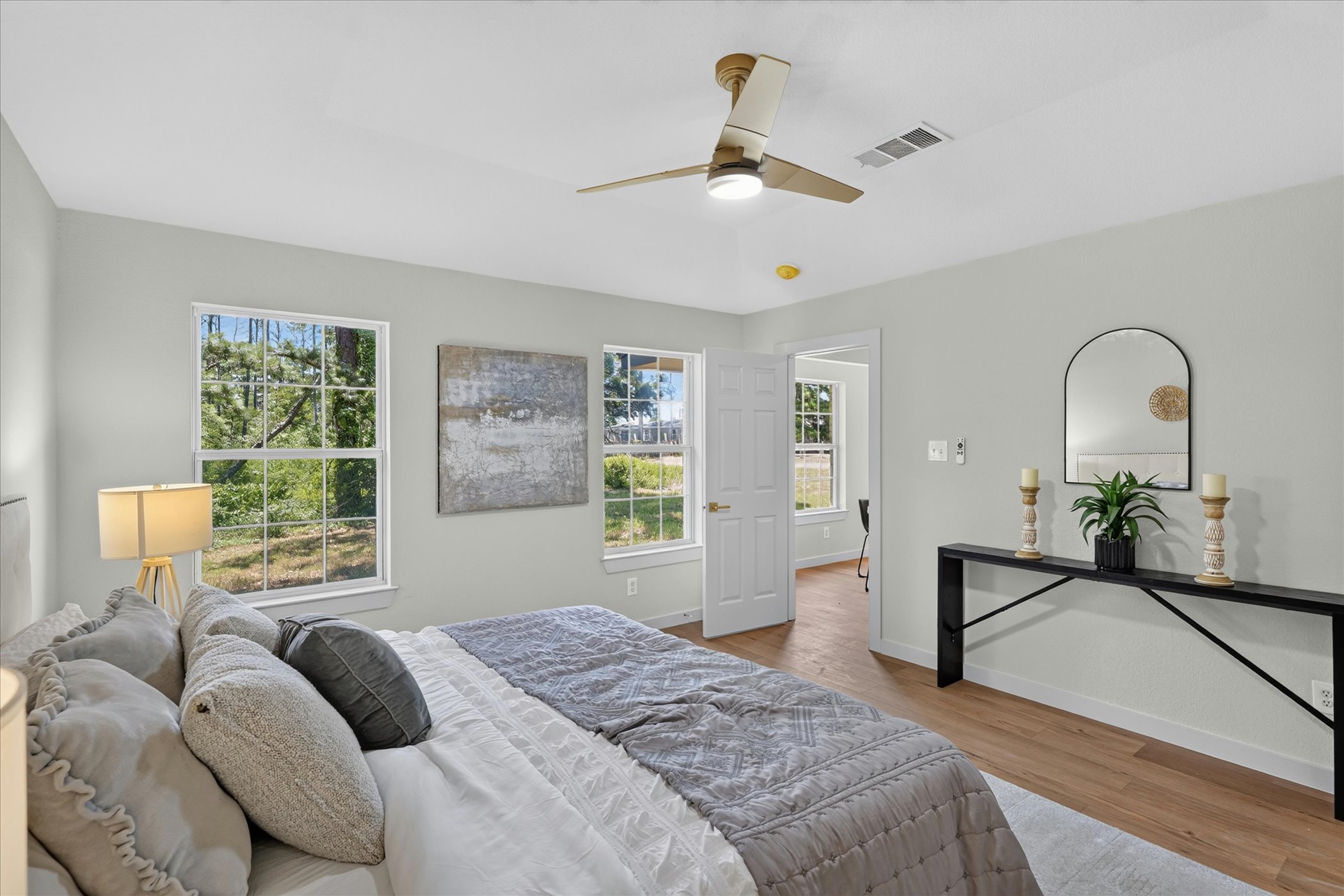 258 Pine View Loop Bastrop, TX 78602 - Photo 28 of 40 Light-filled bedroom featuring elegant flooring and multiple windows framing natural views.