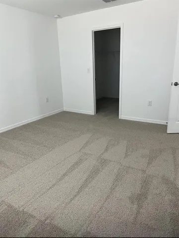 a view of an empty room and closet