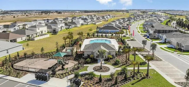 an aerial view of a house with yard swimming pool and outdoor seating